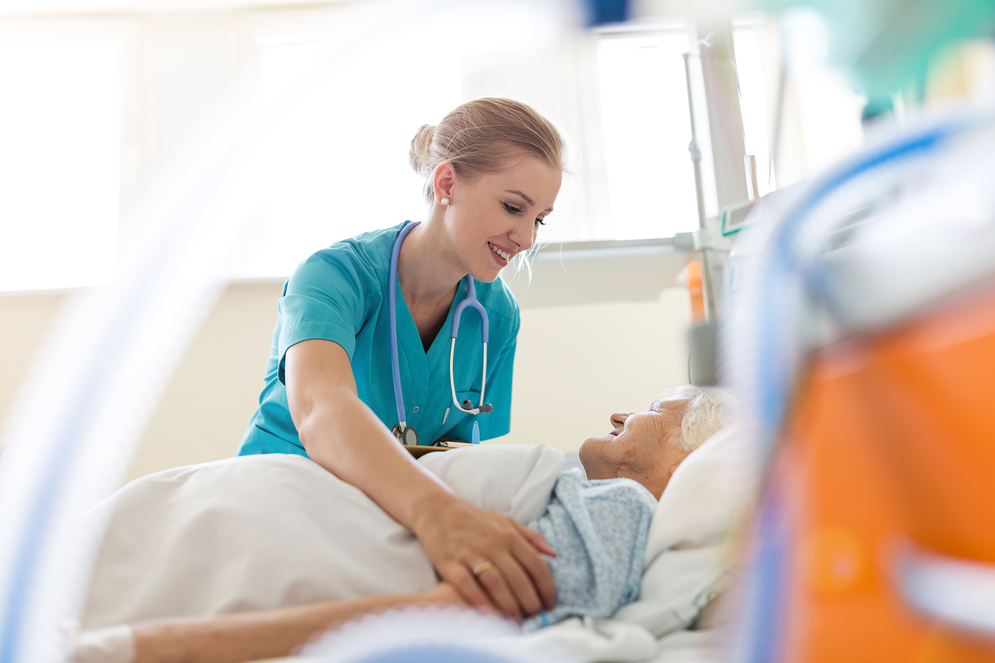 Senior patient and nurse in hospital
